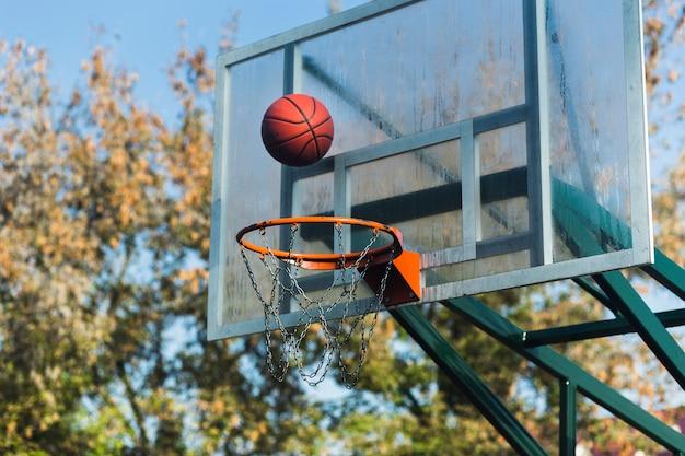 Free photo basketball falling through hoop